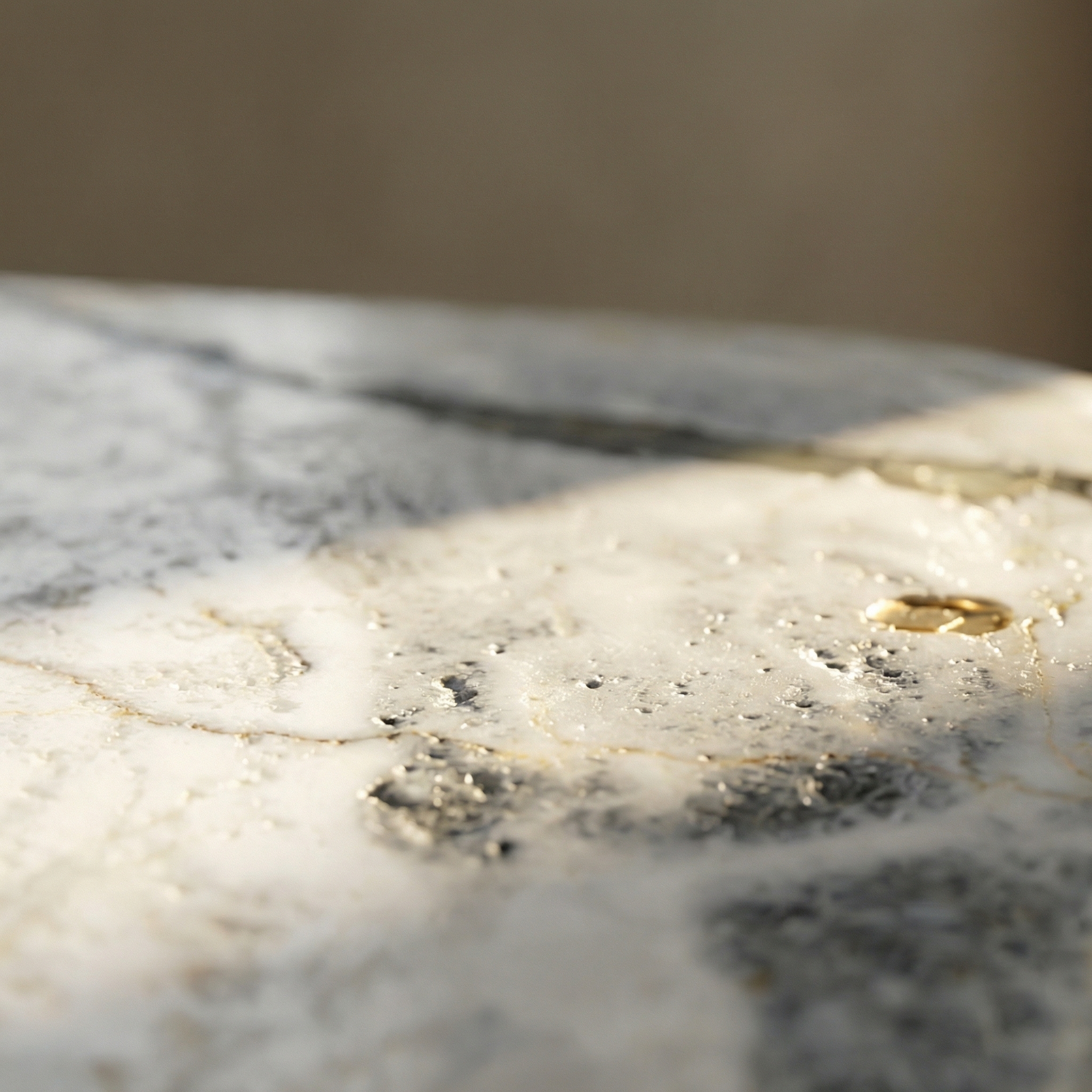 Ana surface detail — honed marble face catching warm light