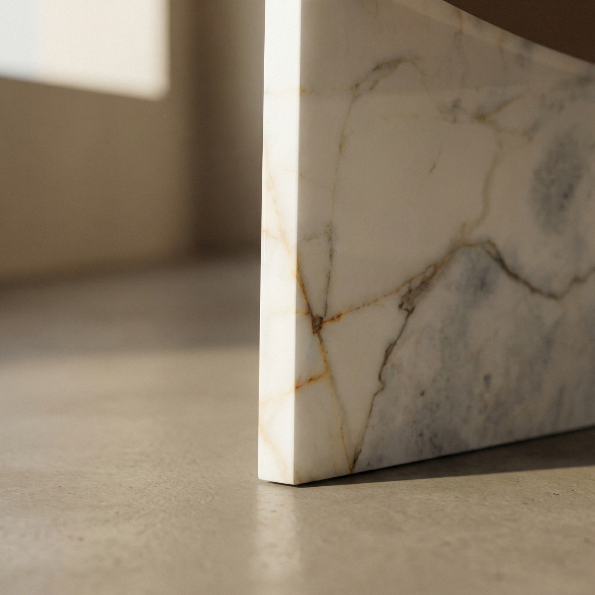 Ana base detail — the marble panel edge meeting the floor