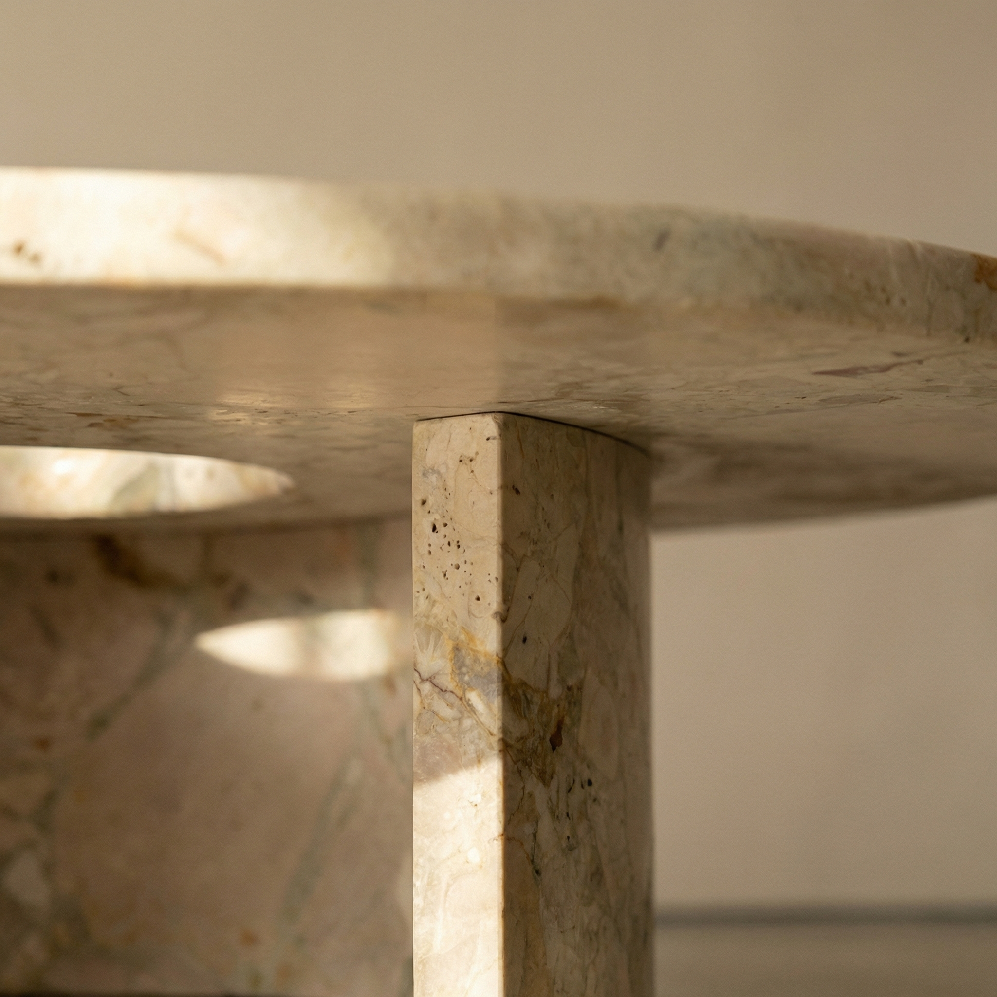 Iron pin joint where the stem meets the marble top