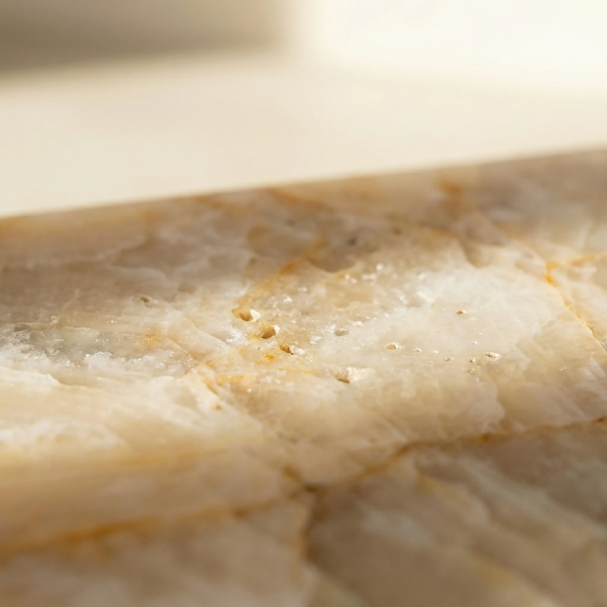 Calacatta Oro surface texture — polished finish catching light